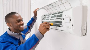 60870042-happy-young-african-male-technician-repairing-air-conditioner